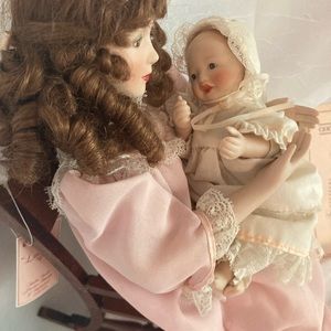 Lullaby Mother and daughter Porcelain dolls in wood rocking chair.  Ashton Drake